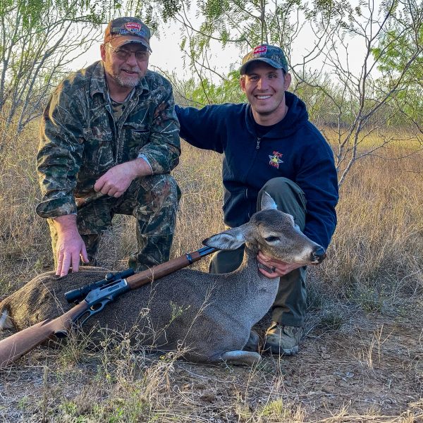 disabled veteran on guided South Texas management doe hunt at The Ranch with harvested whitetail doe