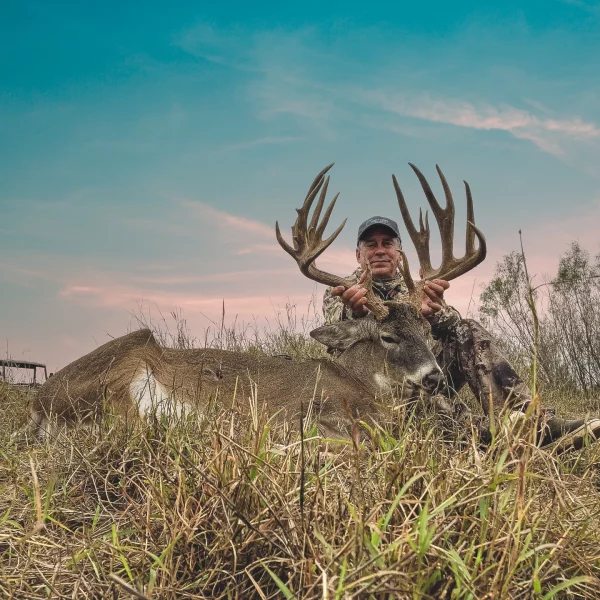 Hunter with trophy whitetail buck at The Ranch in South Texas